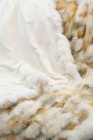 golden island and white fox fur blanket